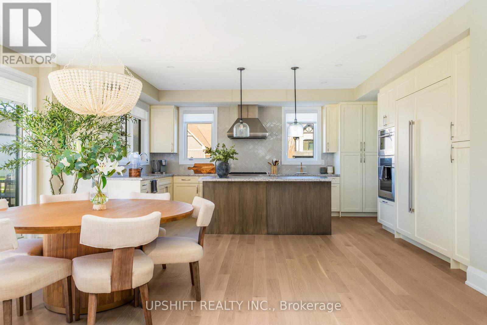 A modern kitchen with a dining table and chairs.