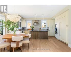 A modern kitchen with a dining table and chairs.