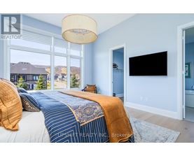 A bedroom with a large bed and a flat screen TV.