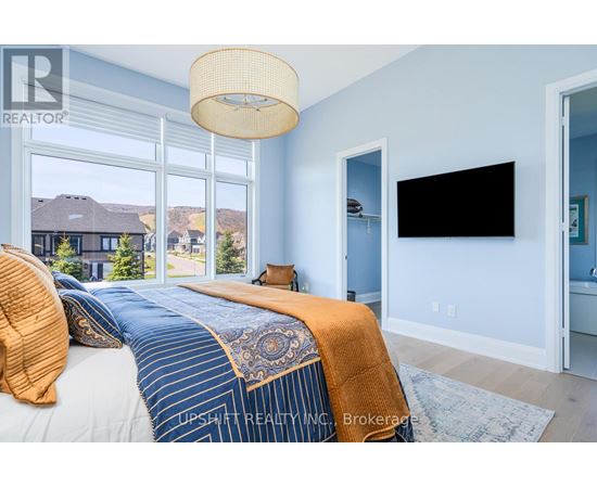 A bedroom with a large bed and a flat screen TV.