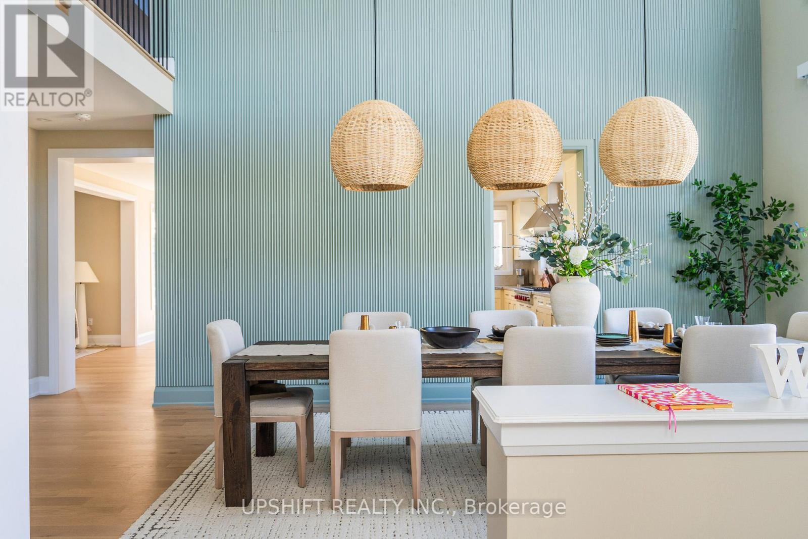 A dining room with a table set for four and a white couch.