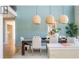 A dining room with a table set for four and a white couch.