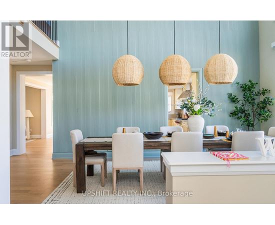 A dining room with a table set for four and a white couch.