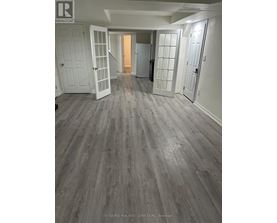 A room with a grey floor and white walls.