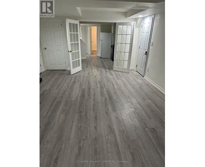 A room with a grey floor and white walls.