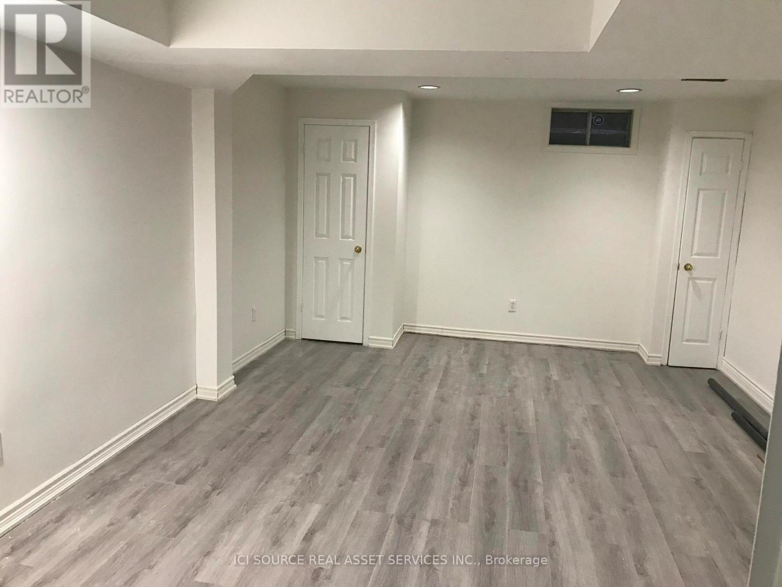 A room with grey flooring and white walls.
