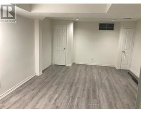 A room with grey flooring and white walls.