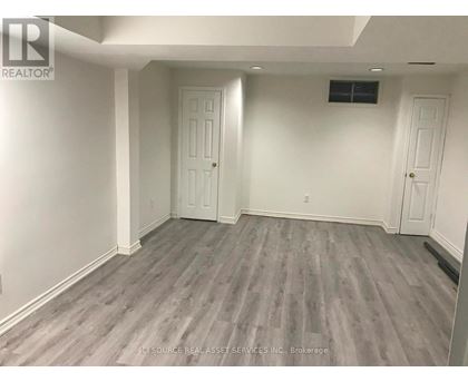 A room with grey flooring and white walls.