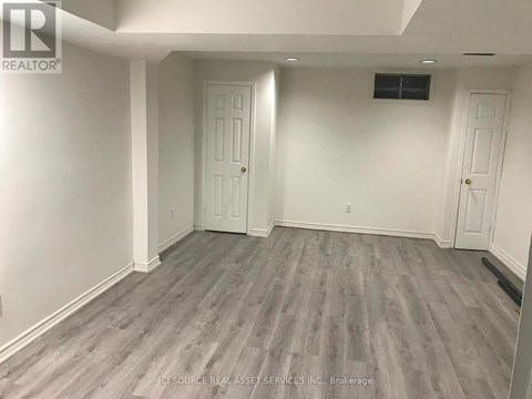 A room with grey flooring and white walls.