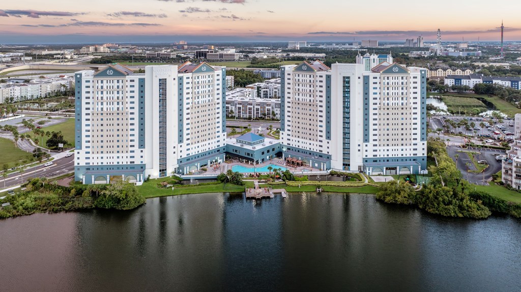 A large hotel complex sits on the edge of a lake.