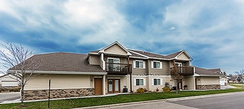 A two-story house with a balcony on the upper floor.
