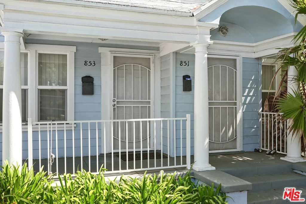 A blue house with the number 851 on the door.