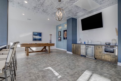 A modern open plan living and kitchen area with a wooden table and chairs.