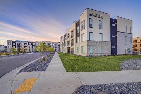 A street view of apartment buildings with the name "Altitude" on the front.