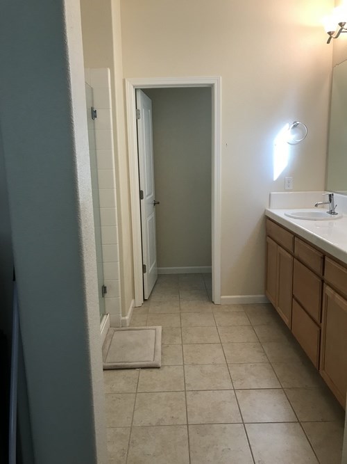 A bathroom with a sink, mirror, and toilet.