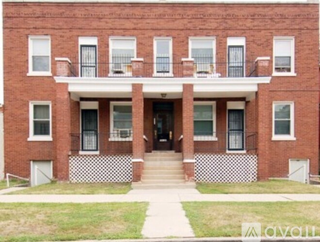 A red brick building with a black and white checkered pattern on the steps.