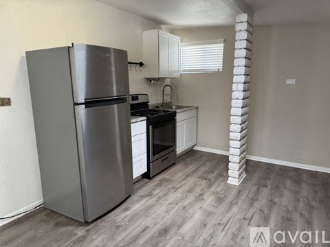 A kitchen with a refrigerator, stove, and oven.