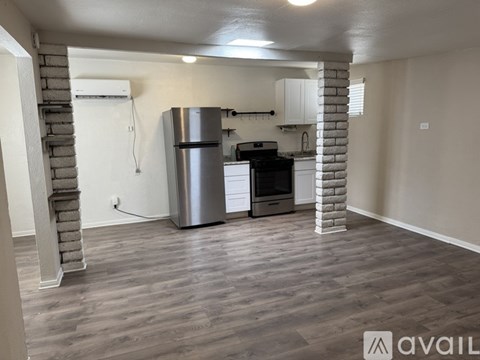 A kitchen with a stainless steel refrigerator, oven, and microwave.