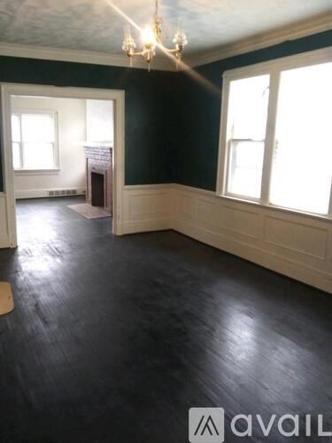 A room with a fireplace and a chandelier.