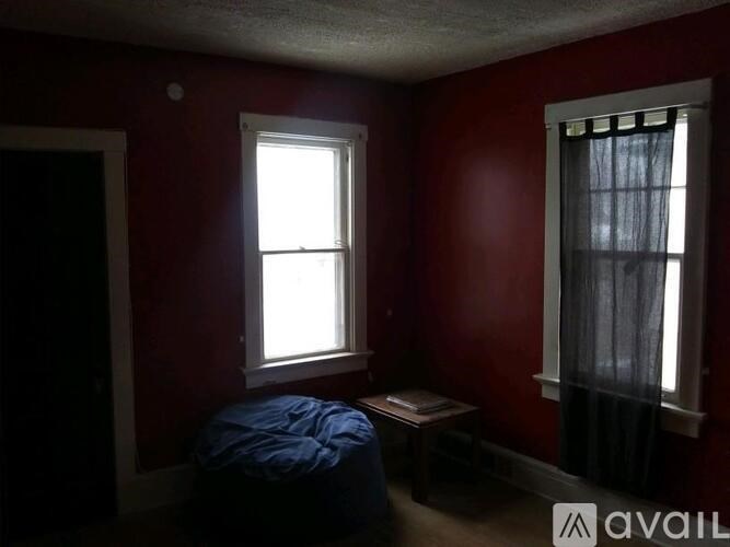 A room with red walls and a window.