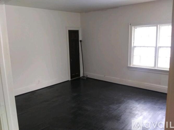 A room with a black floor and white walls.