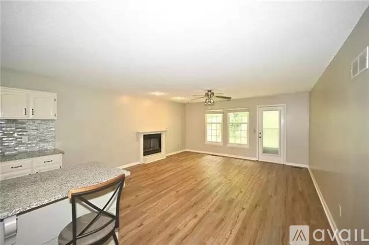 A room with a fireplace and a ceiling fan.
