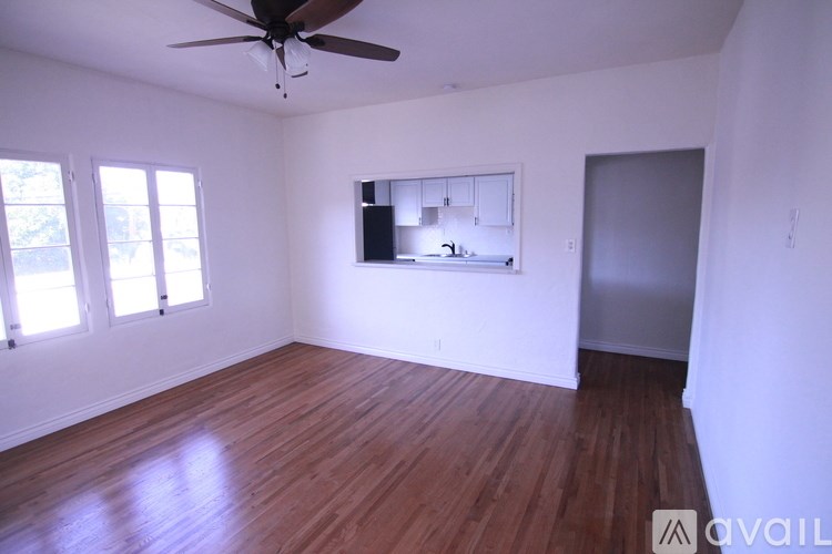 A room with wooden floors and a ceiling fan.