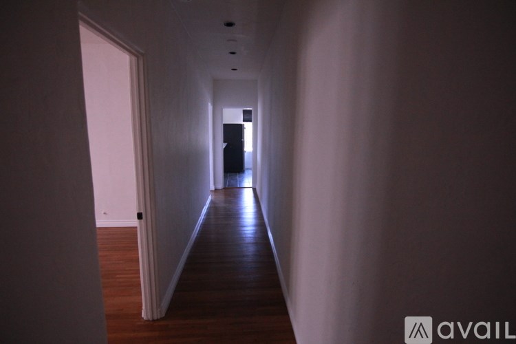 A long hallway with a door at the end.