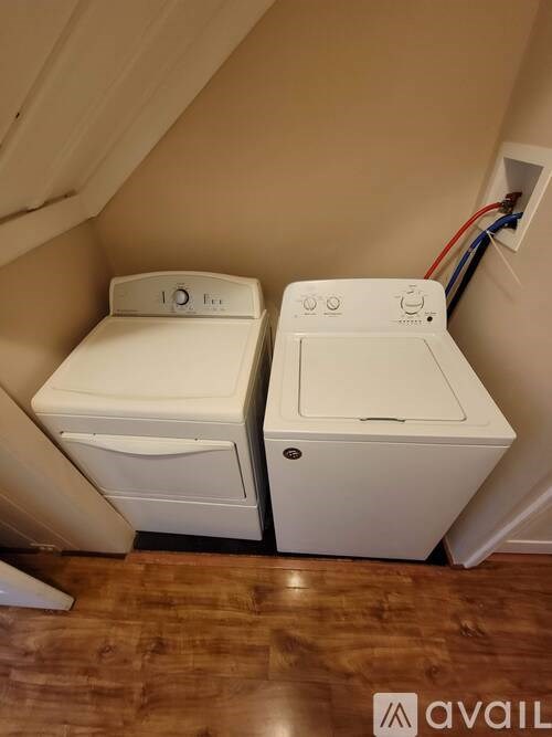 Two white toilets in a small room.