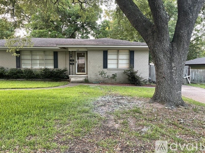 A house with a tree in front of it.