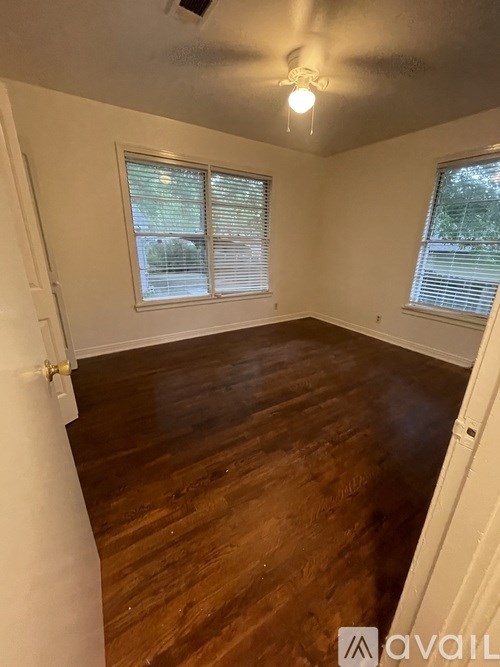 A room with wooden floors and white walls.