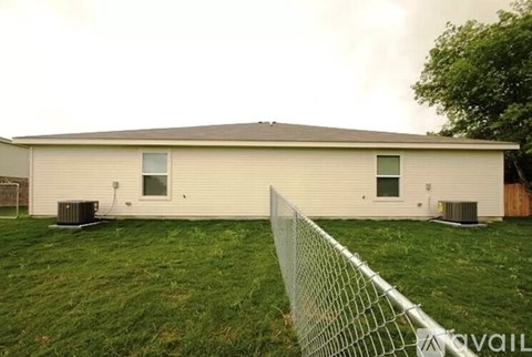A house with a fence in front of it.