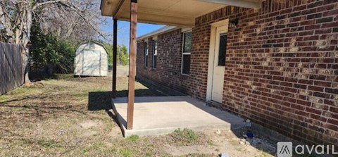 A brick house with a porch and a sign that says "available".