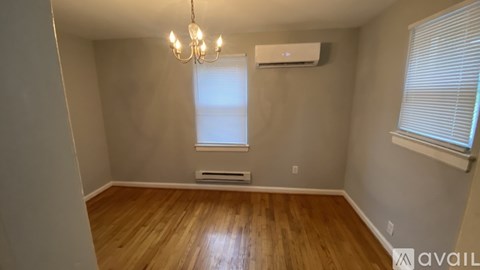 A room with wooden floors and a chandelier.