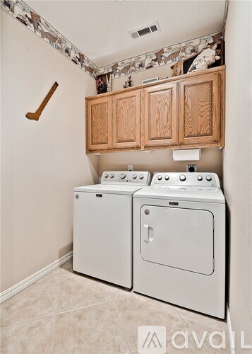 A white washer and dryer in a laundry room.