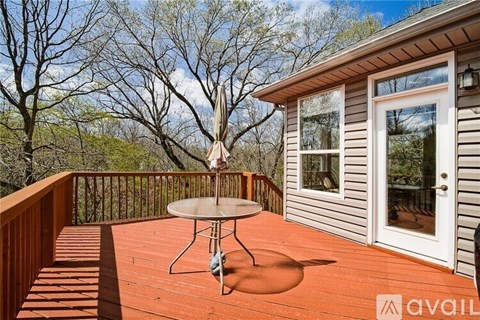 A wooden deck with a table and chairs is shown.