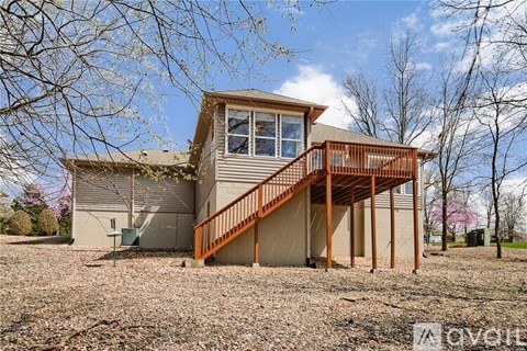A house with a brown deck and a brown roof.