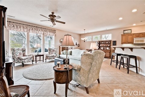 A living room with a sofa, armchair, and a coffee table.