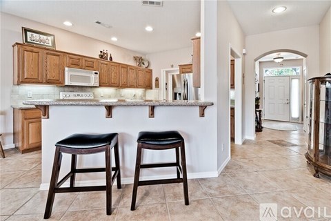 Two black bar stools are in front of a kitchen island.