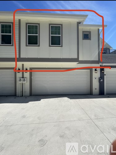 A house with a white garage door and a red line drawn on the image.