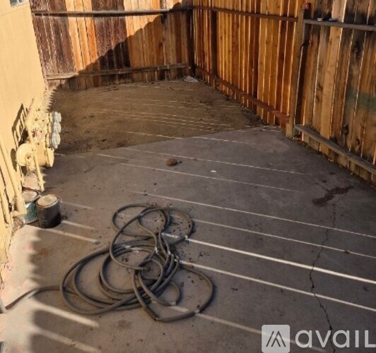 A pile of hoses sits on a concrete floor.