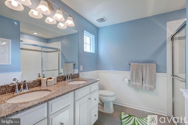 A bathroom with two sinks and a toilet.