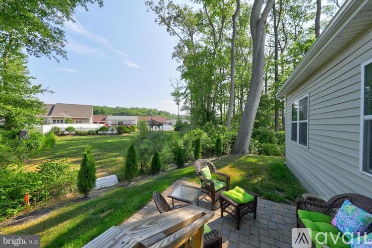 A backyard with a wooden table and chairs.