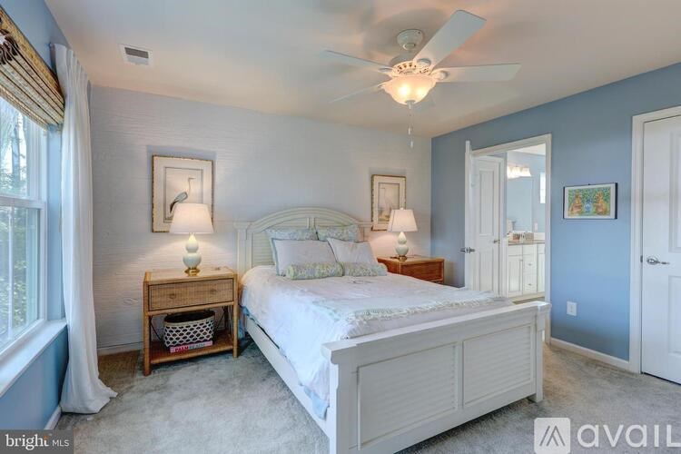 A bedroom with a bed, nightstand, and two lamps.