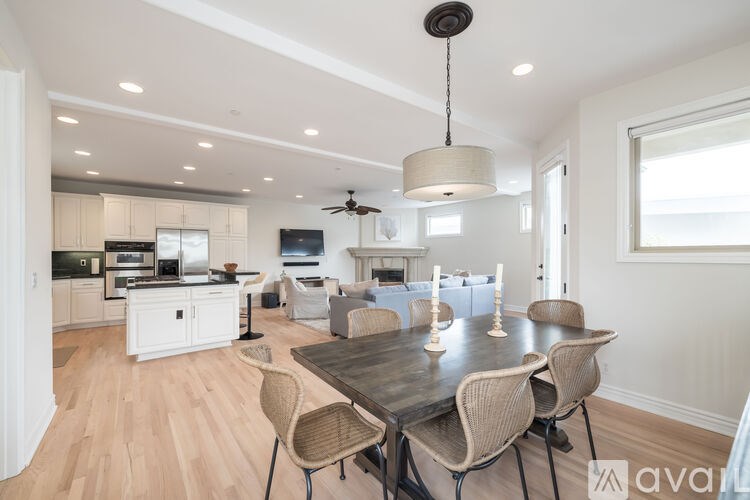 A modern dining room with a wooden table and chairs.