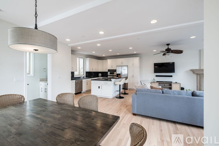 A modern kitchen with a dining table and chairs.