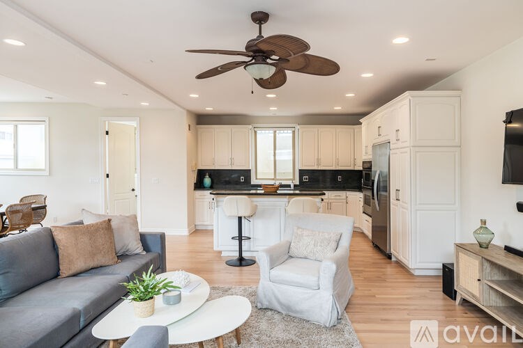 A living room with a grey couch and a white coffee table.