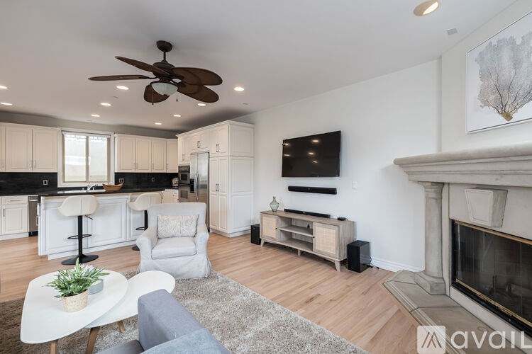 A living room with a fireplace and a television.
