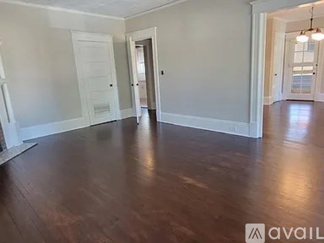 A room with wooden floors and white walls.