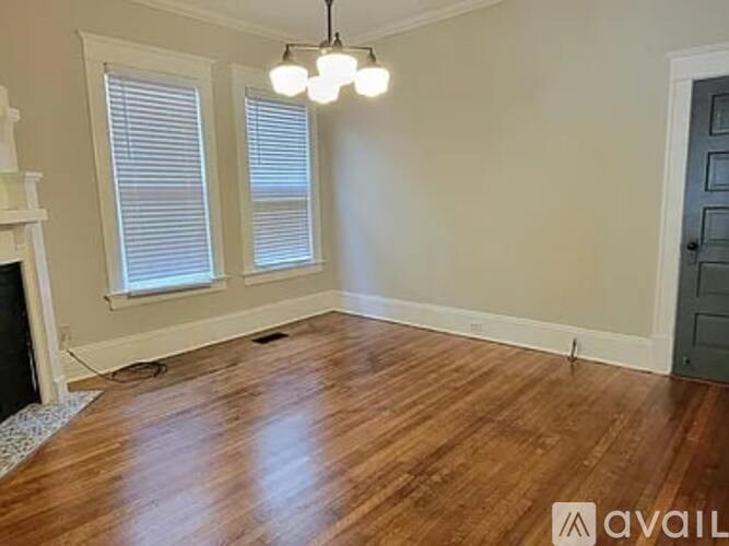 A room with wooden floors and a fireplace.